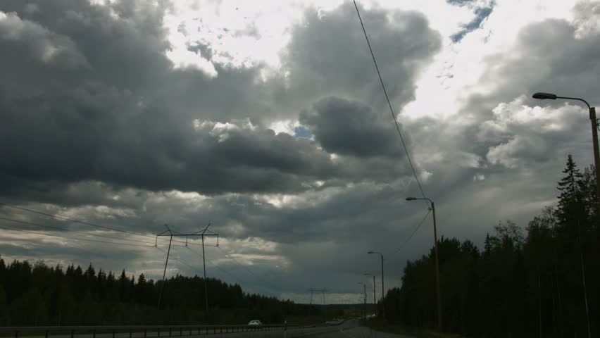 Timelapse of clouds moving above a highway