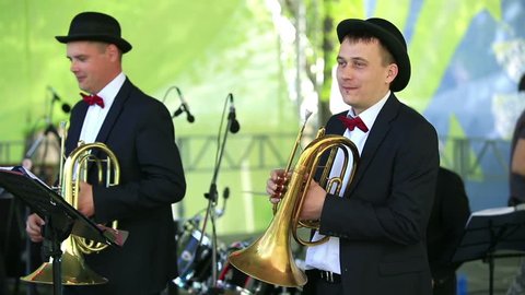 MOSCOW, RUSSIA - MAY 09, 2015: Two cornet in the orchestra. Brass Band performing on the stage in the park. Festival marching bands in the city park "Muzeon."