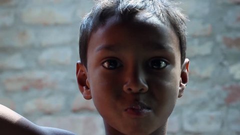 Cute Indian village boy eats and plays. Video de stock