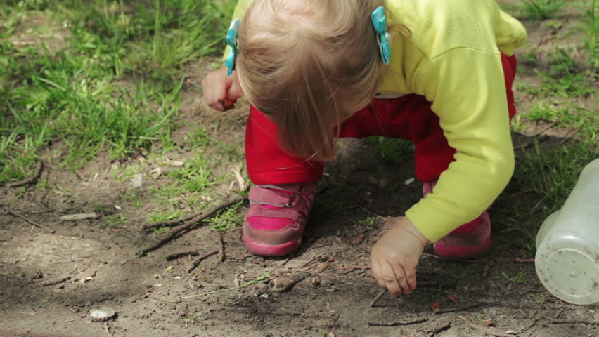 On dacha girl playing with earth
