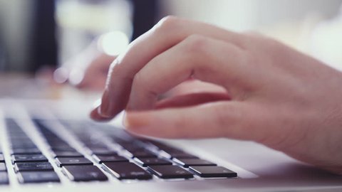 Closeup of business woman hand typing on laptop keyboard. Closeup of a female hands busy typing on a laptop. Woman's hands pressing keys on a laptop keyboard trying to access data.