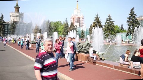 MOSCOW - MAY 18, 2014: People near fountains in park of VDNKH. Exhibition of Achievements of national economy (VDNKH) - largest exposition, museum and recreational complex in world