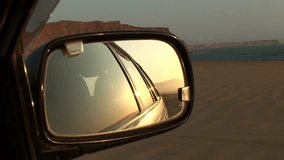 Video footage of driving on a country road in the desert in the the Paracas National Park in Peru in 2007