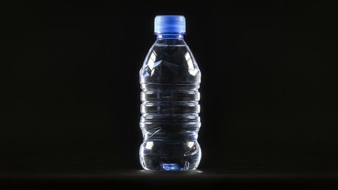 Small Water Plastic Bottle Rotates On Stock Footage Video (100